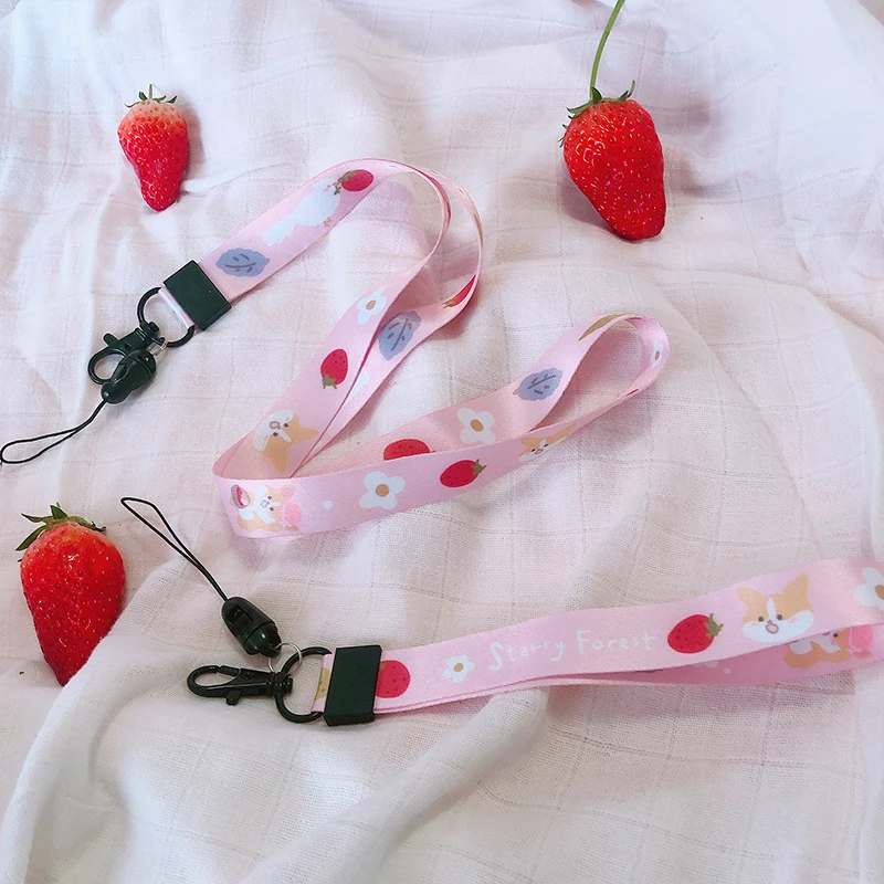 ŽVAIGŽDĖTAS MIŠKO Žemuogių mielas mobiliųjų telefonų dirželiai ant kaklo ir rankos riešo mergina rožinė diržu, telefoną ir fotoaparatą